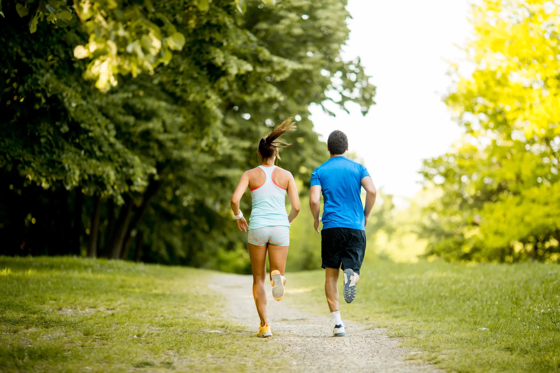 active couple running in green city park utc